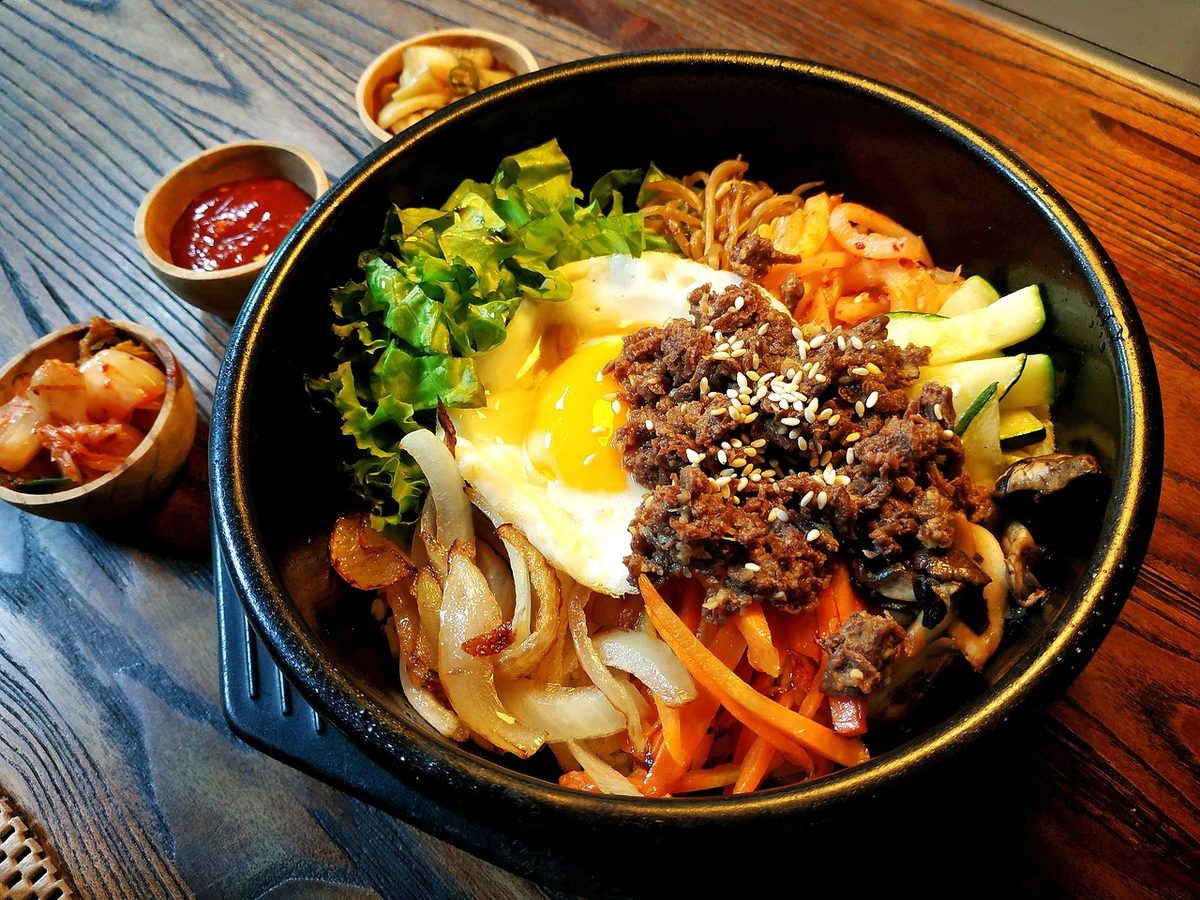 Finished Korean bibimbap with rice, vegetables, gochujang, and egg