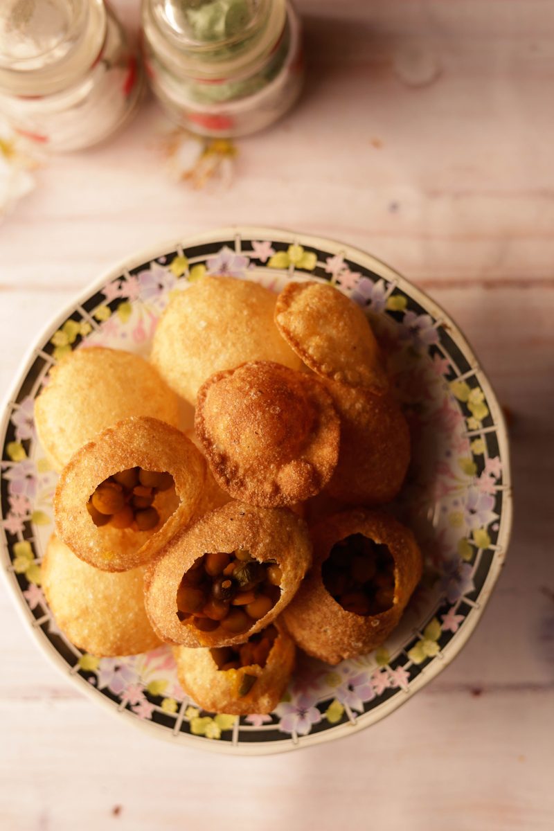 Finished pani puri (golgappa) with potato filling on a ceramic plate