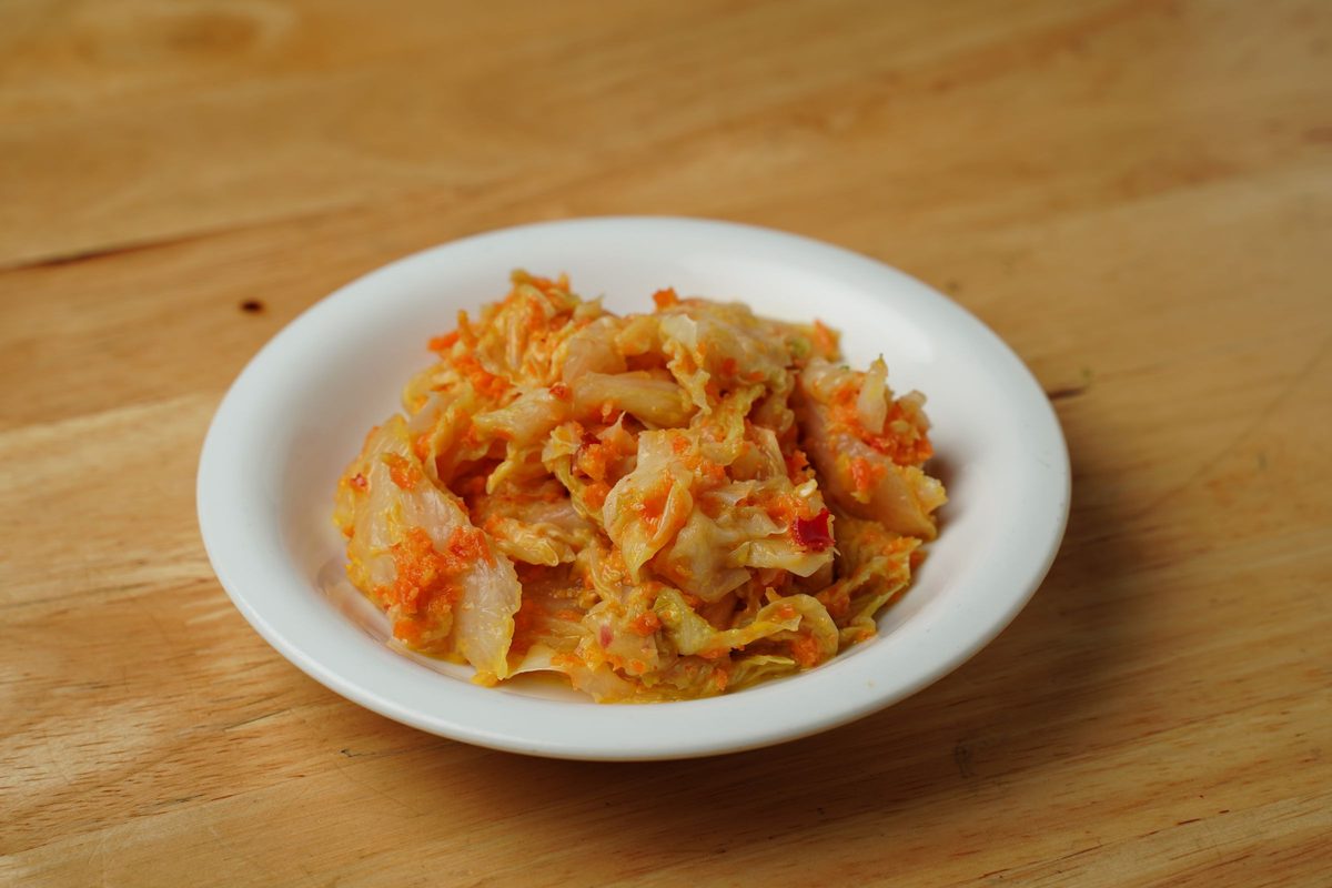 Finished cabbage kimchi served in a white ceramic bowl