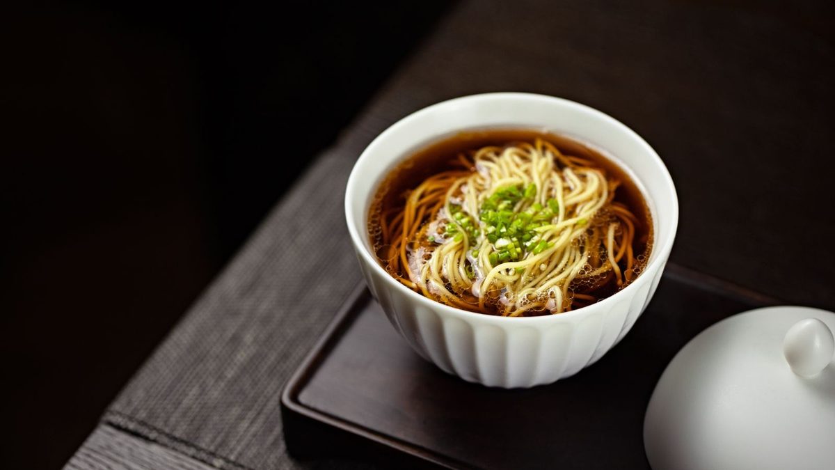 Dashi Japanese soup stock served as soba noodle broth with green onions