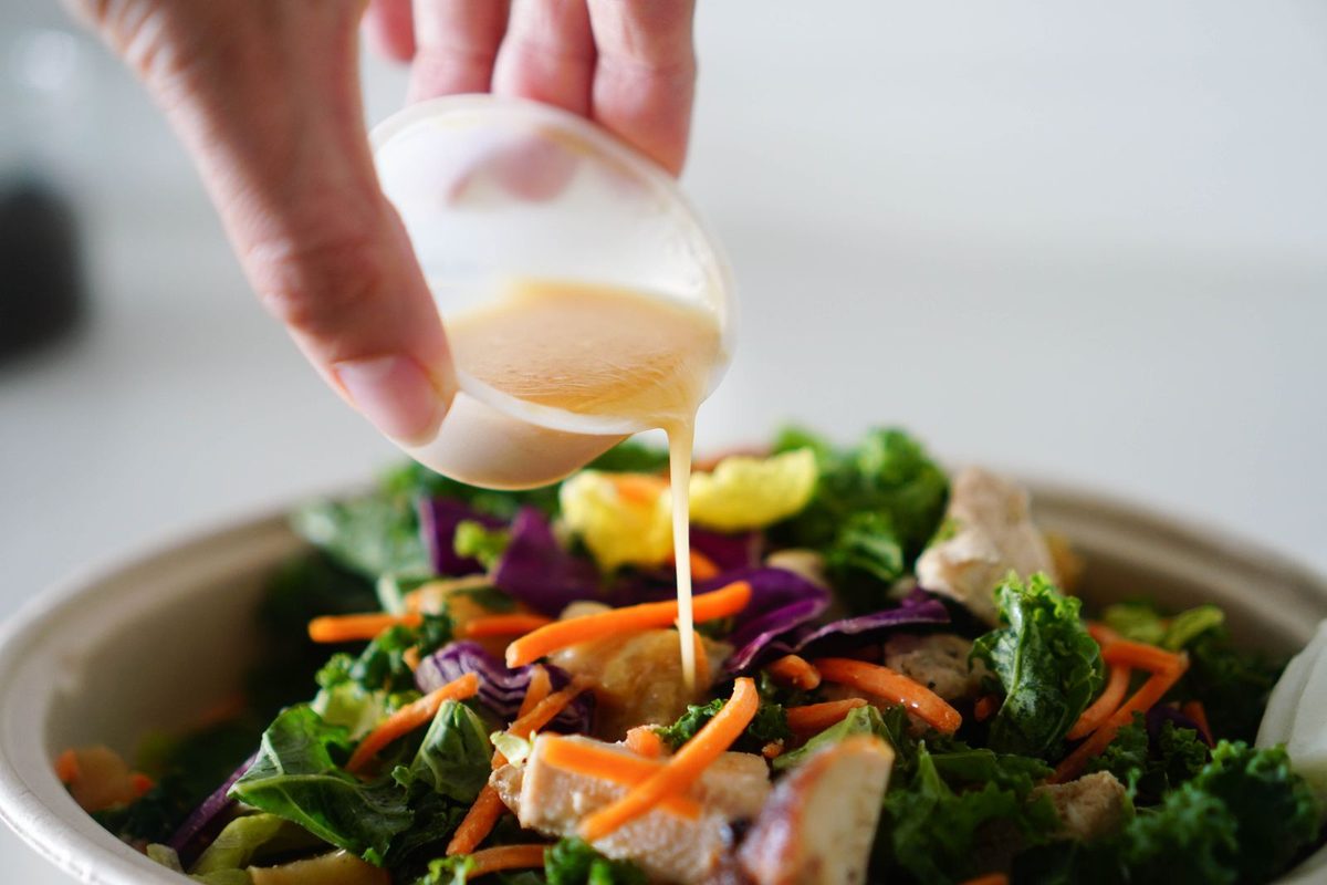 Finished French dressing poured over a fresh green salad