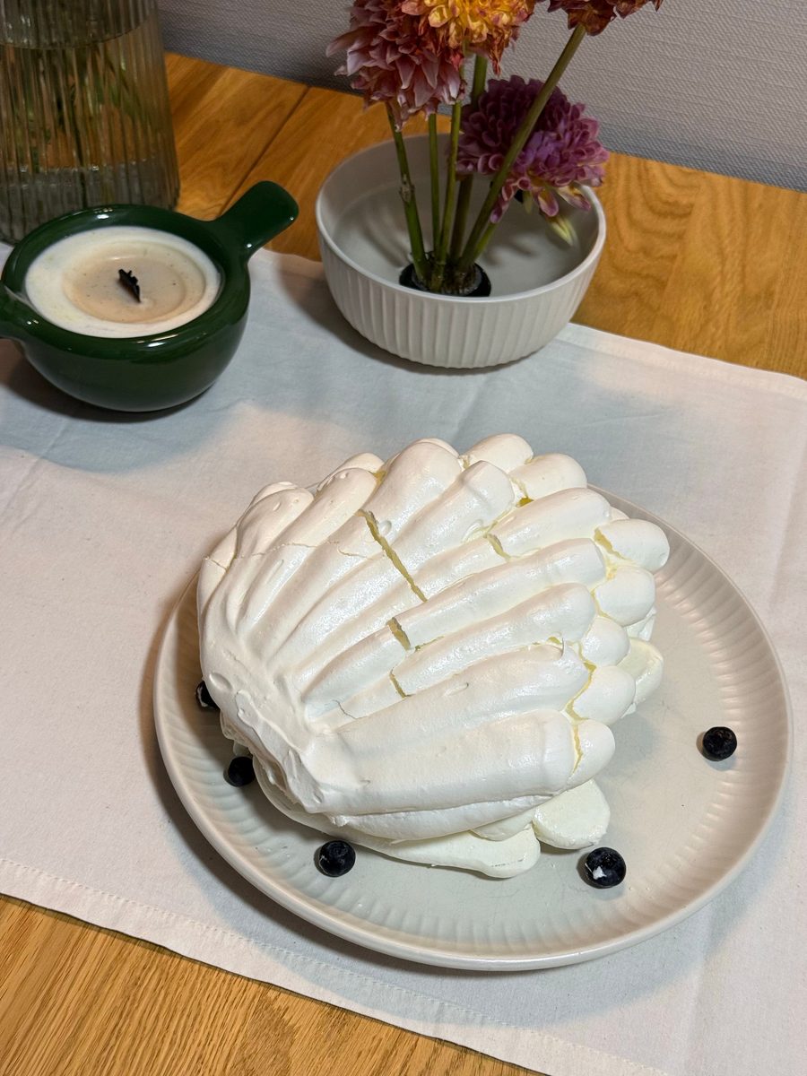 Finished French meringue dessert garnished with blueberries on a plate
