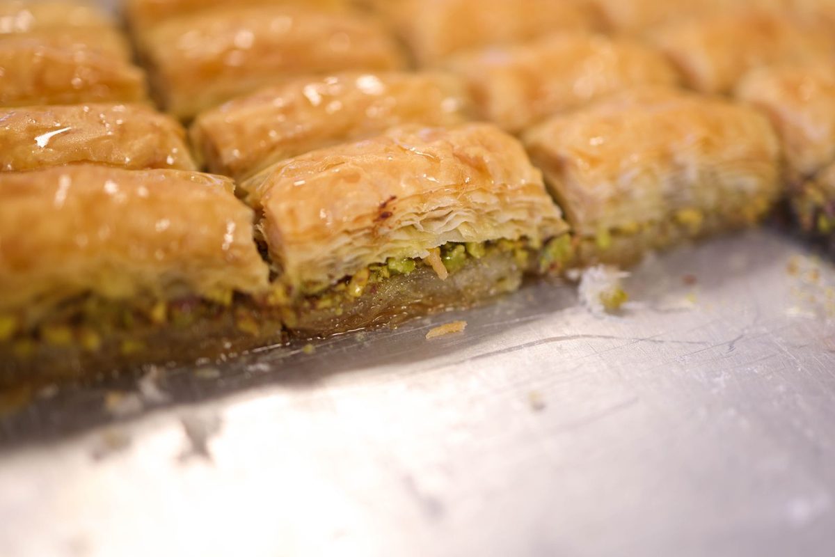 Galaktoboureko (Greek semolina custard pastry), a golden syrup-soaked phyllo pastry slice.