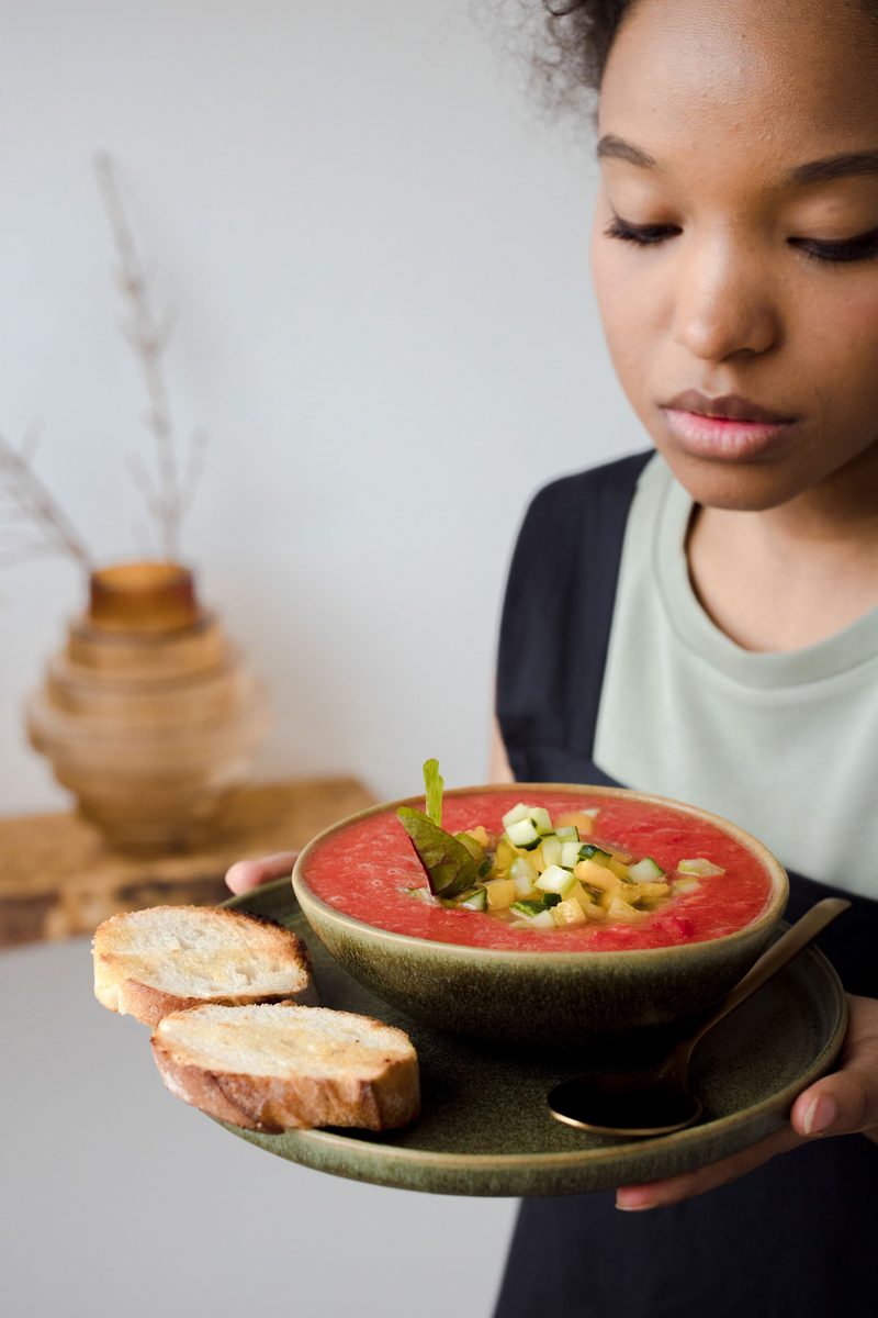 Finished gazpacho served in a bowl with bread