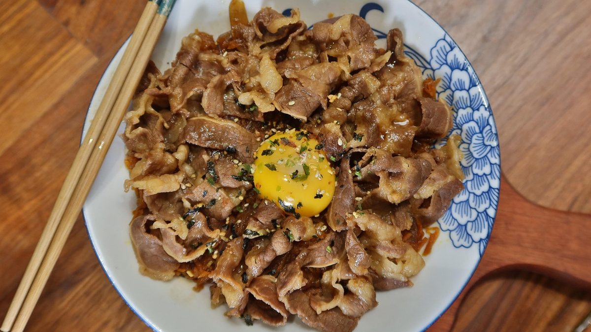 Finished Gyudon Japanese beef and rice bowl with sliced beef over steamed rice