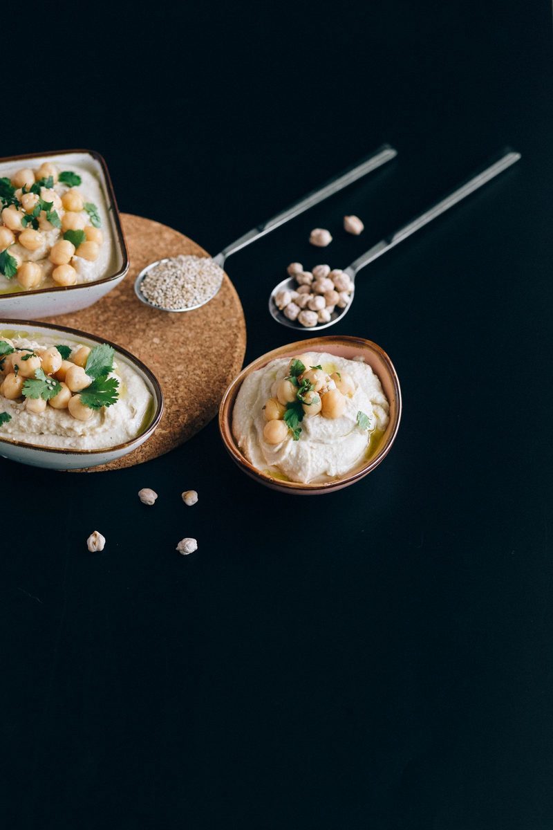 Bowl of creamy Greek hummus garnished with chickpeas