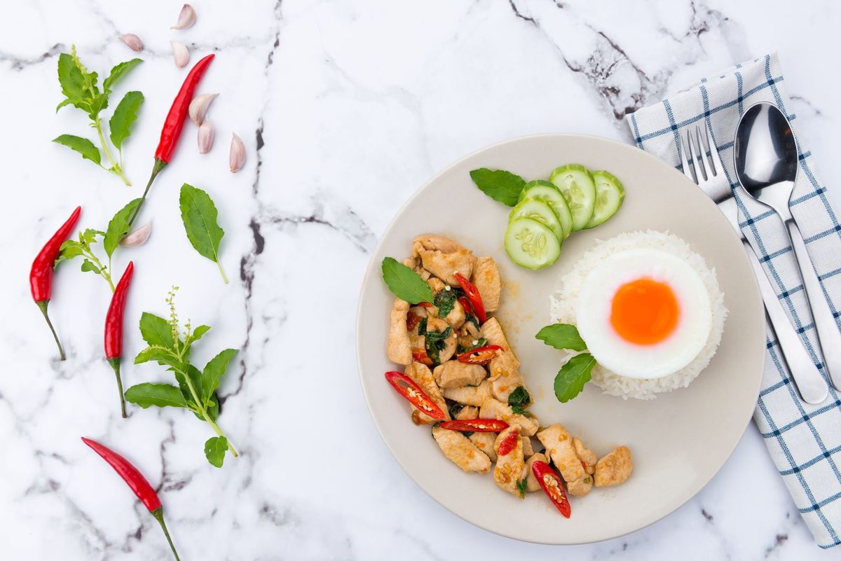 Finished Pad Kra Pao Gai Thai basil chicken stir-fry with rice and fried egg
