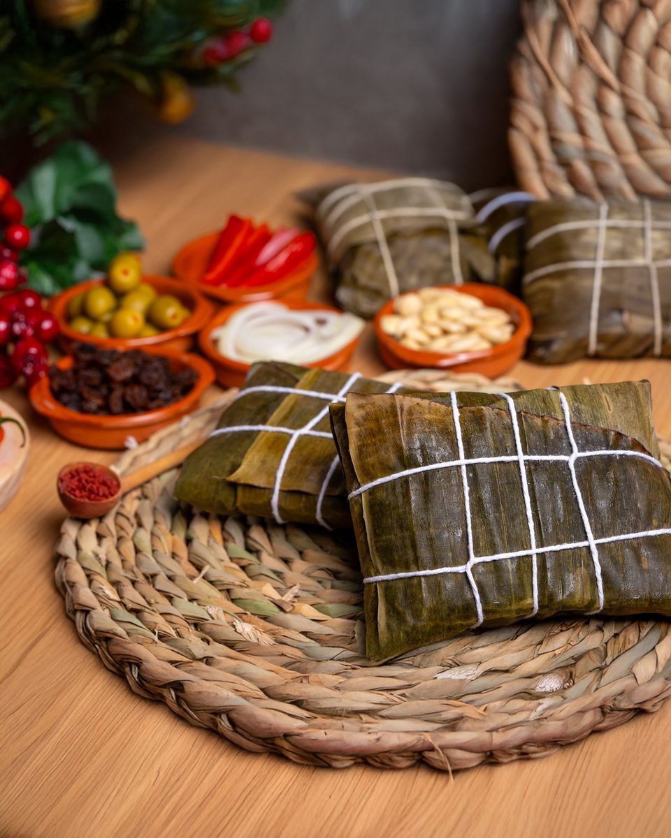 Finished rice tamale (pastel de arroz) wrapped in a banana leaf and served on a woven mat