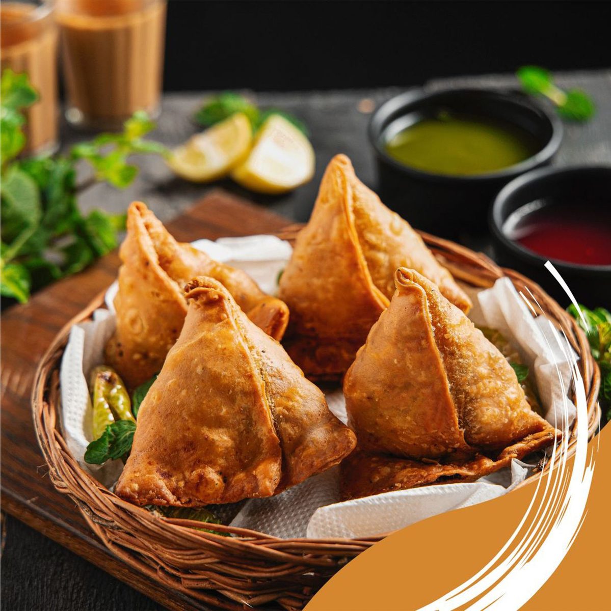 Golden fried potato-and-pea samosas served with mint and tamarind chutney