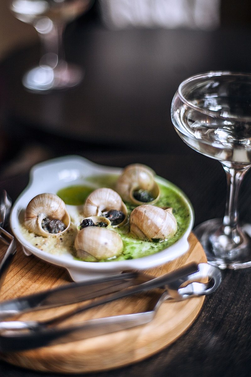 Finished escargots à la Bourguignonne snails served with garlic butter and herbs