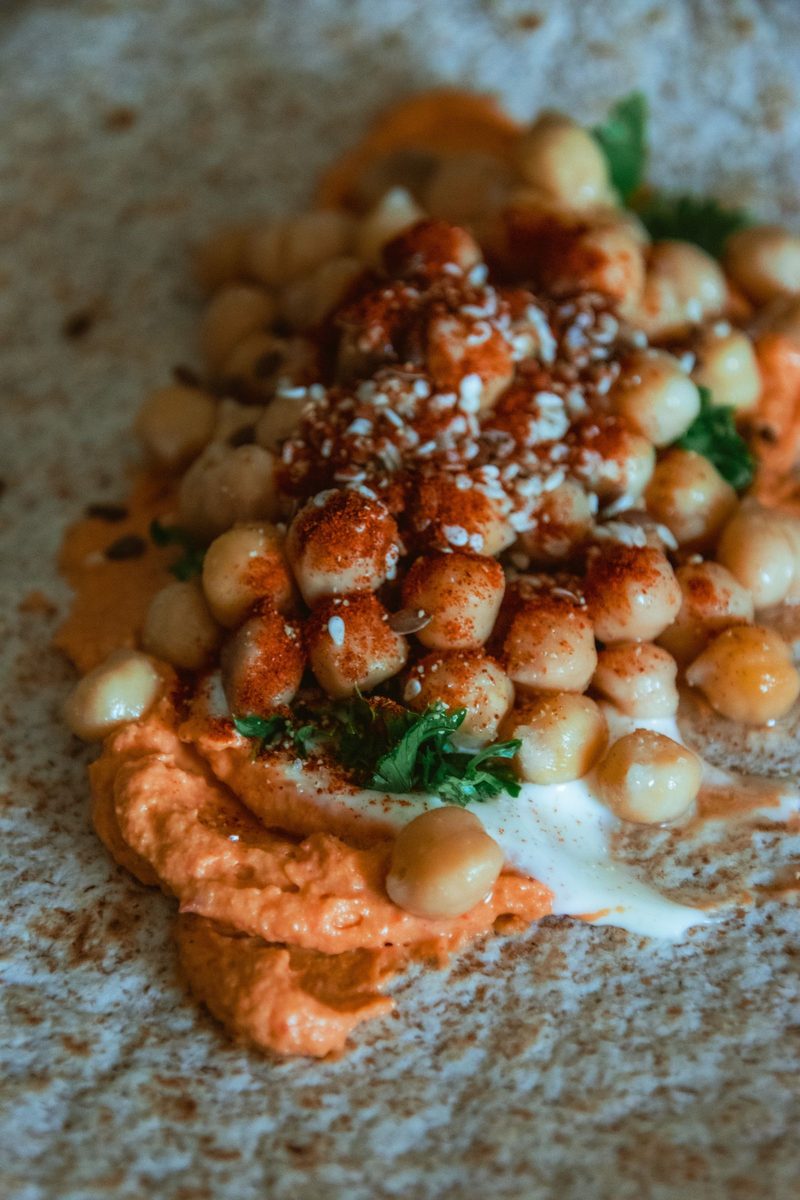 Finished Socca (Italian chickpea flatbread) served as a golden chickpea flatbread wrap with creamy sauce and fresh herbs