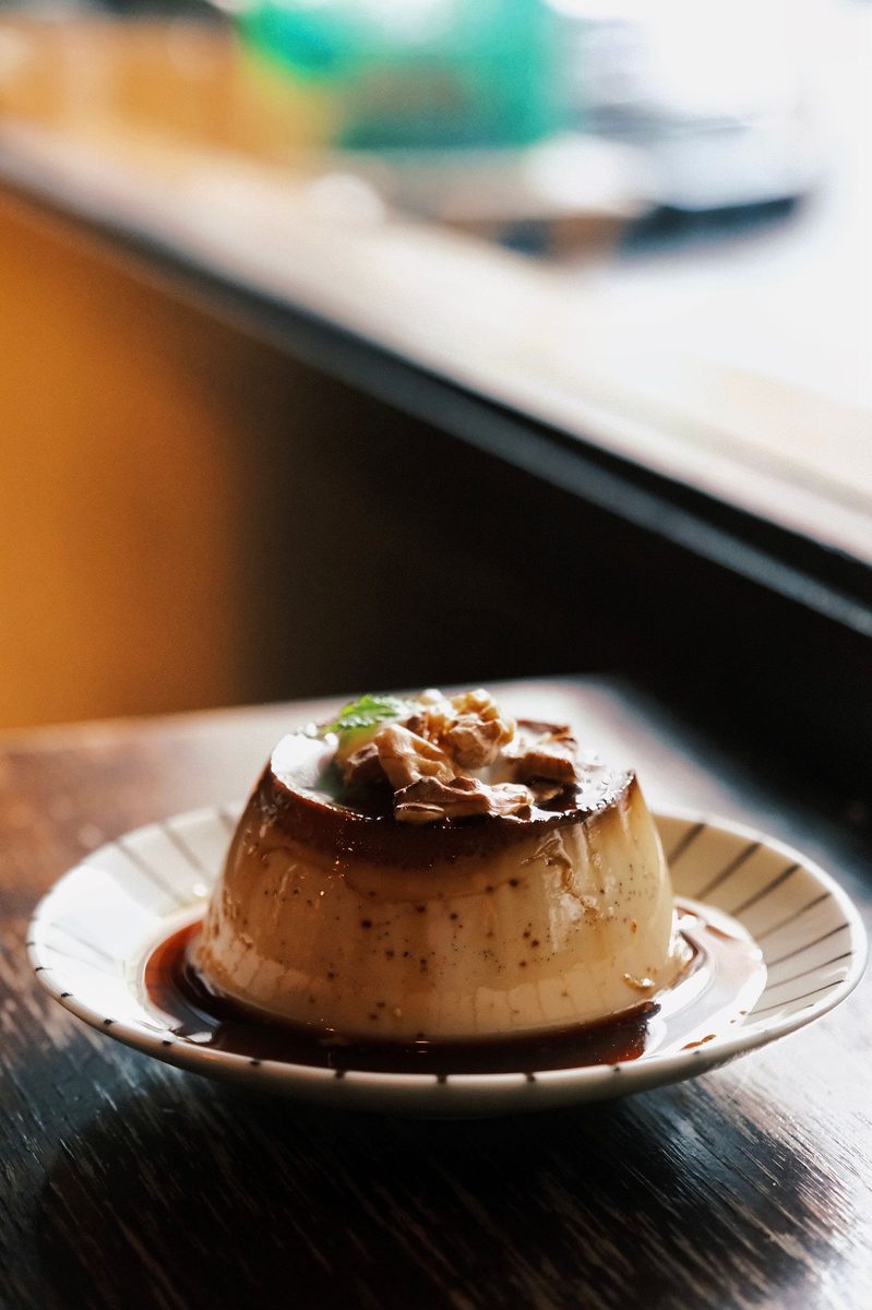 A finished caramel flan dessert styled on a plate.