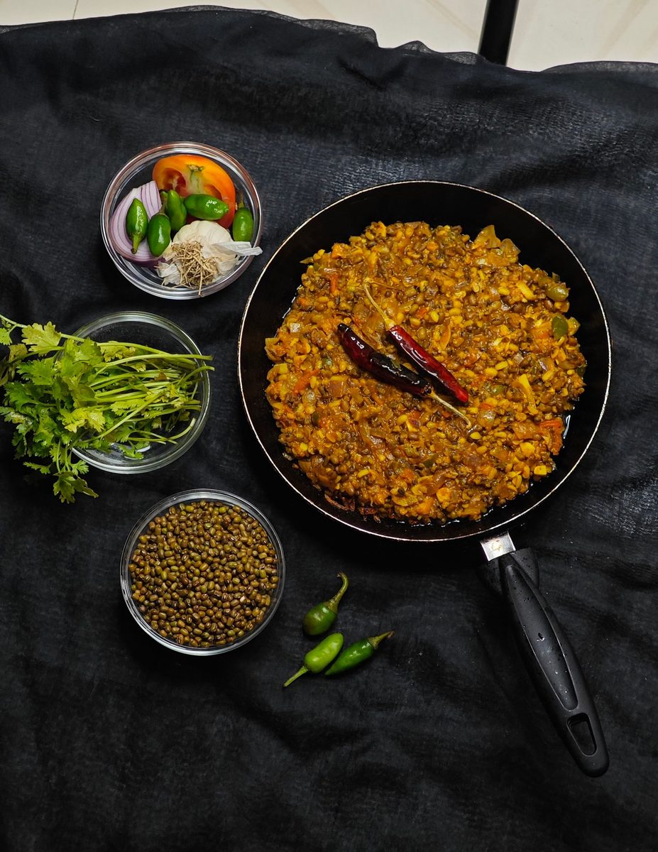 Finished tadka dhal (spiced lentil curry) served with fresh herbs and spices