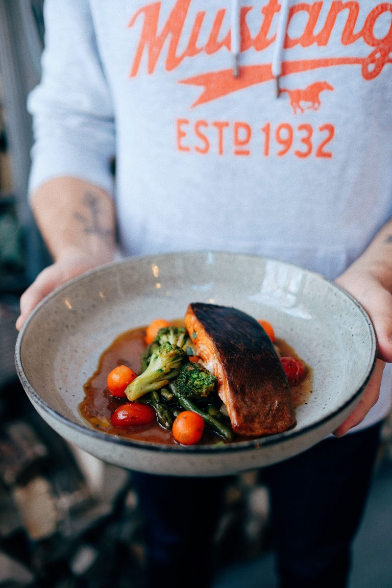Teriyaki-glazed grilled salmon steak with broccoli and tomatoes