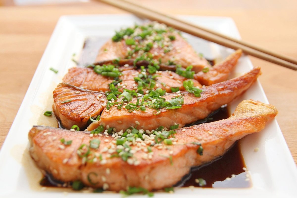Finished teriyaki salmon fillet glazed with dark teriyaki sauce on a plate