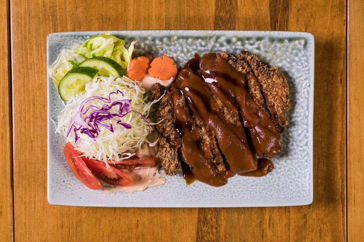 Finished tonkatsu pork cutlet with shredded cabbage and sauce