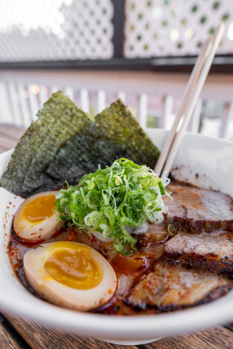 Finished bowl of tonkotsu ramen with chashu pork, soft-boiled eggs, scallions, and nori