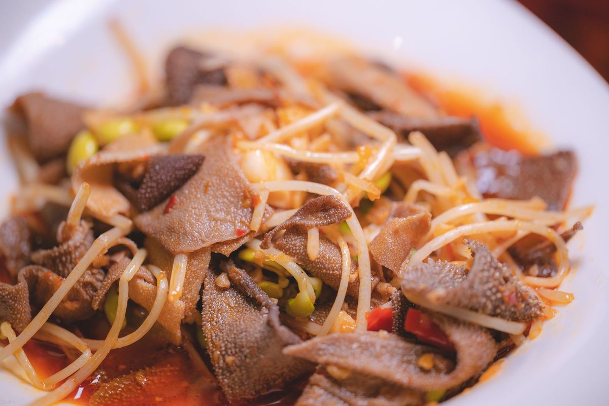 Tripes à la mode de Caen (Norman stewed tripe), a finished tripe dish served on a white plate